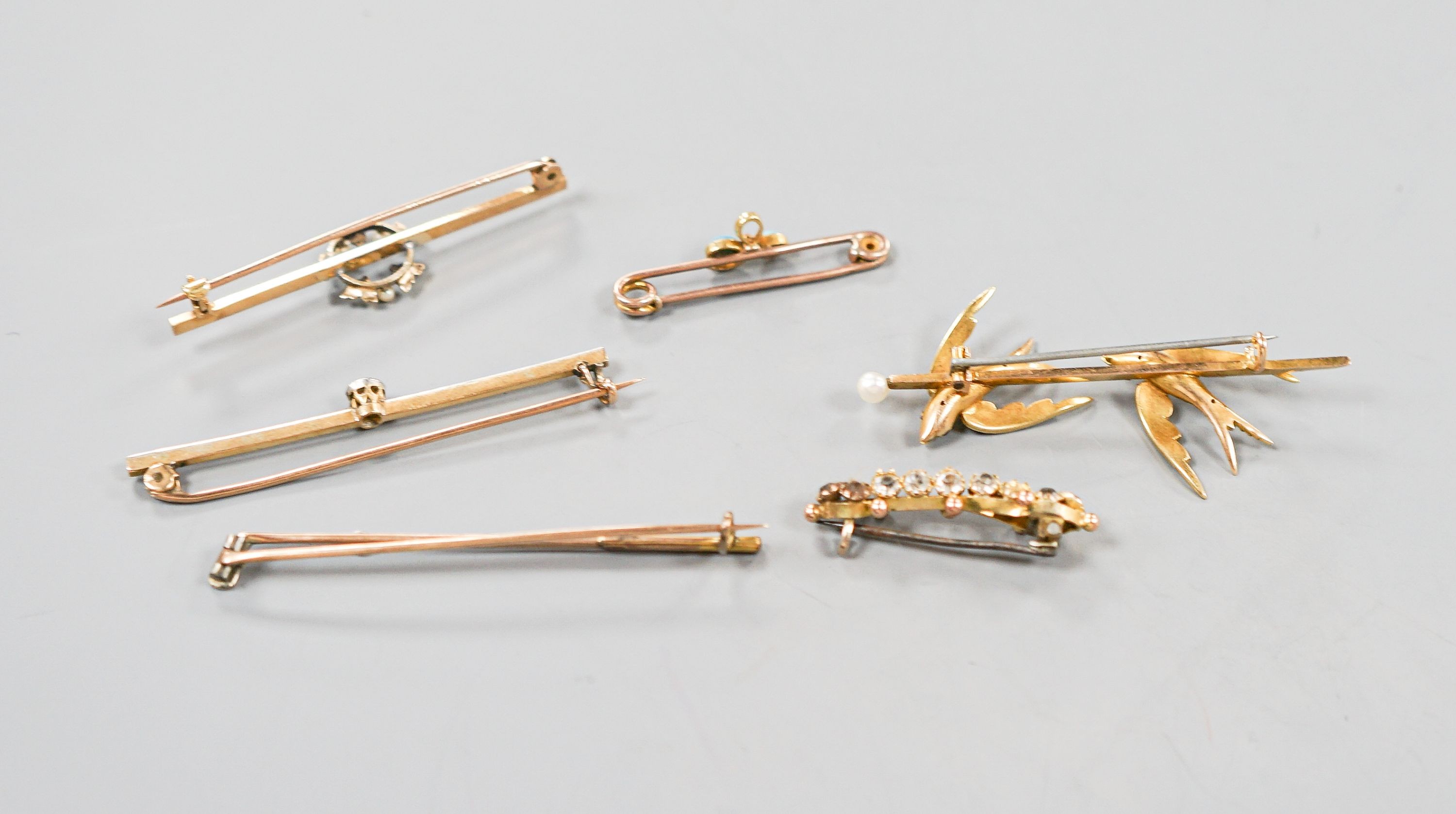 A collection of six assorted yellow metal bar brooches, including seed pearl set twin swallow, diamond set gold club and solitaire diamond set